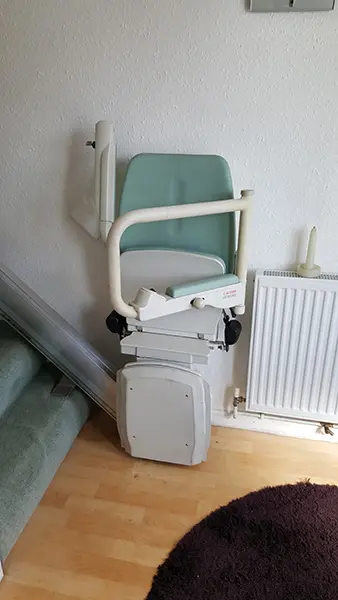 bison bede compact straight stairlift folded at the bottom of the stairs